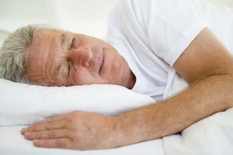 2015-07-man-lying-in-bed-sleeping