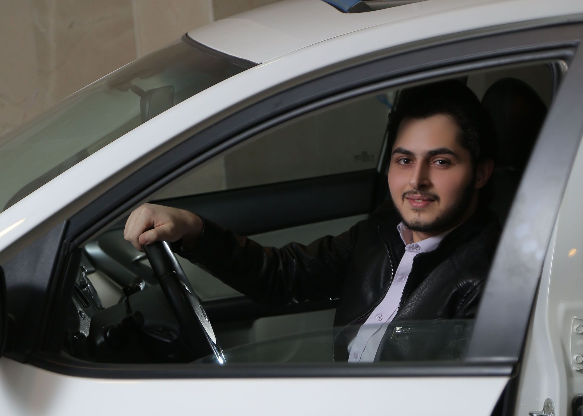 یک مرد در ماشین سفید خوشحال 