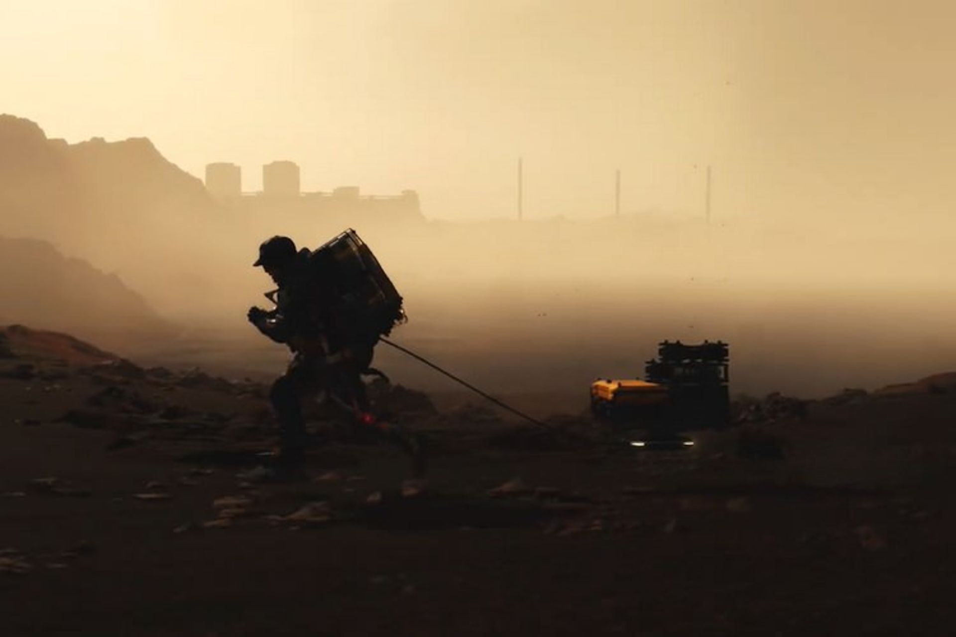 قهرمان بازی Death Stranding در حال رساندن بار در جهان این بازی