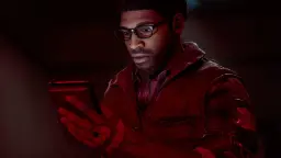 مردی با عینک و ژاکت قهوه‌ای در حال نگاه کردن به یک تبلت در نور قرمز بازی Silent Hill Townfall
