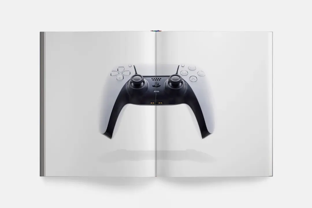 دسته بازی پلی‌استیشن (PlayStation) روی صفحات یک کتاب باز